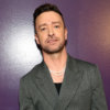 Justin Timberlake leaning against a purple wall